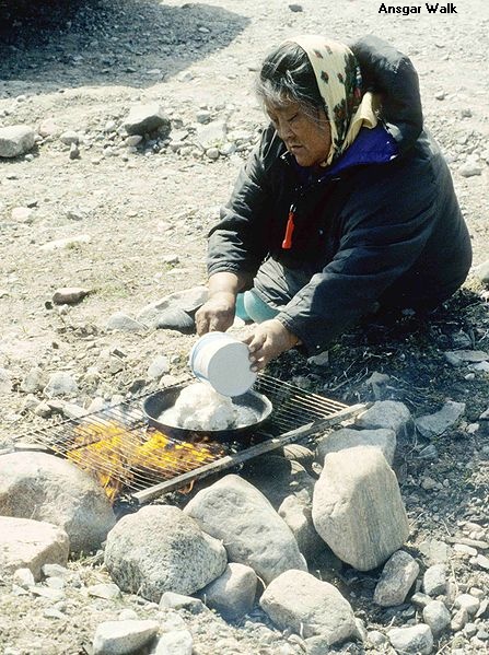 photo of woman baking bannock by Ansgar Walk